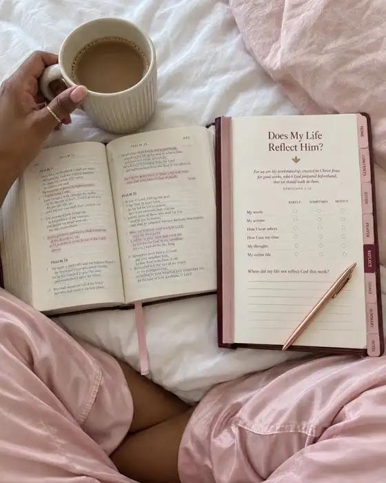 The printed journal open on a bed beside a Bible and a cup of coffee